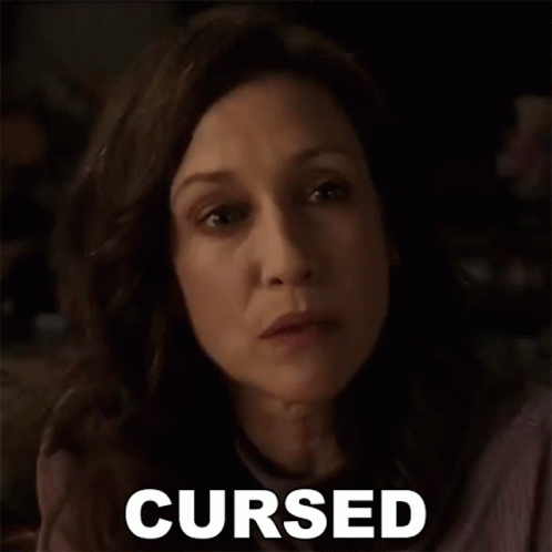 A Close Up Of A Woman 'S Face With The Word Cursed Written Next To Her . GIF