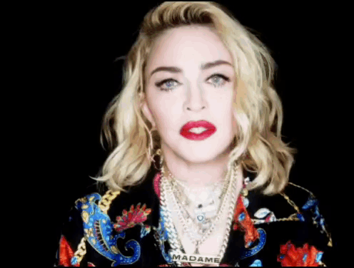 A Close Up Of A Woman 'S Face With The Word Madame On Her Neck GIF