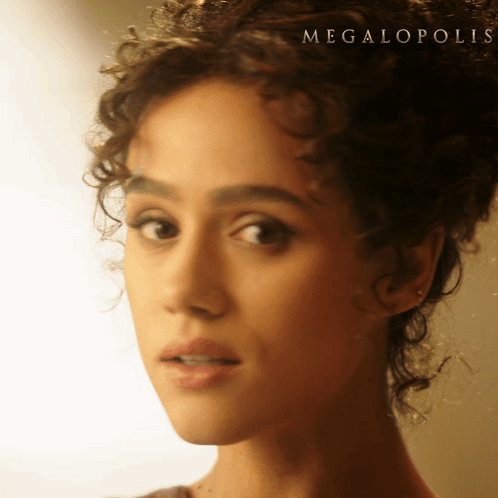 A Close Up Of A Woman 'S Face With The Word Megalopolis On The Bottom Right GIF