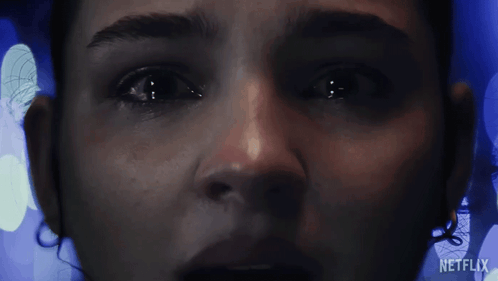 A Close Up Of A Woman 'S Face With The Word Netflix On The Bottom Right GIF