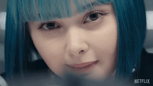 A Close Up Of A Woman 'S Face With The Word Netflix On The Bottom Right GIF