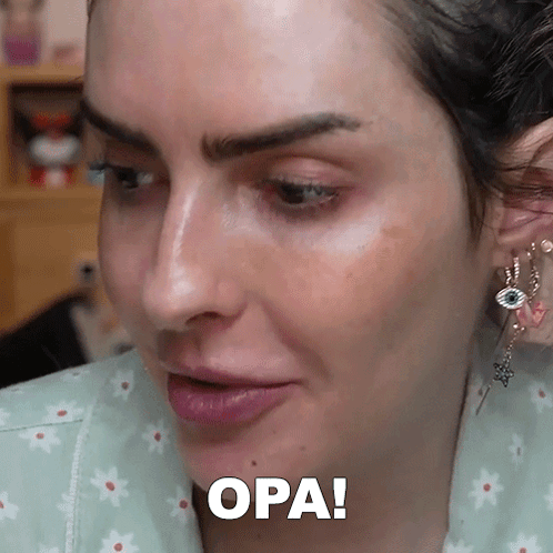 A Close Up Of A Woman 'S Face With The Word Opa Written Below It GIF