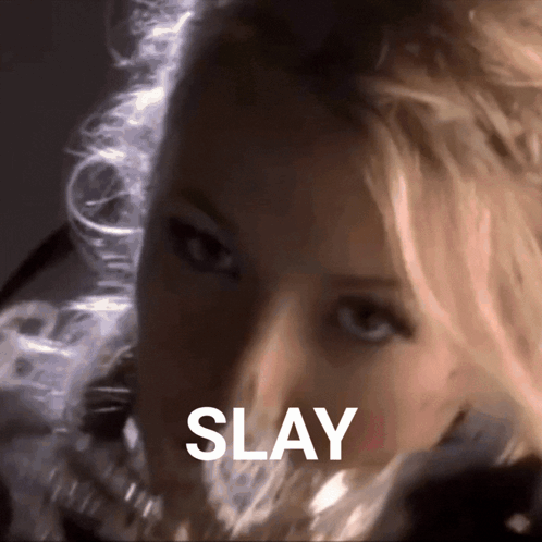 A Close Up Of A Woman 'S Face With The Word Slay Written Above Her GIF