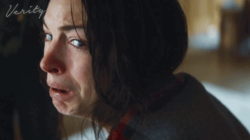 A Close Up Of A Woman 'S Face With The Word Verity On The Bottom Right GIF