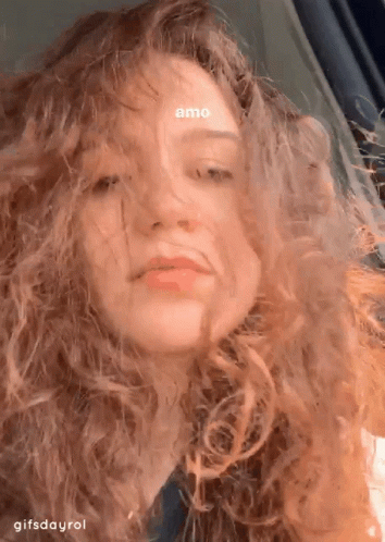 A Close Up Of A Woman 'S Face With The Words Amo On Her Forehead GIF