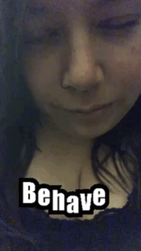 A Close Up Of A Woman 'S Face With The Words Behave Written On It . GIF