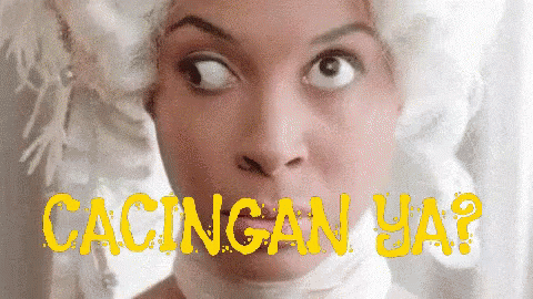 A Close Up Of A Woman 'S Face With The Words Cacingan Ya In Yellow GIF