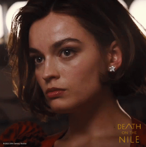 A Close Up Of A Woman 'S Face With The Words Death On The Nile GIF