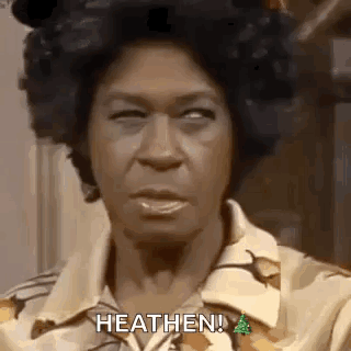 A Close Up Of A Woman 'S Face With The Words `` Heathen '' Written On It . GIF