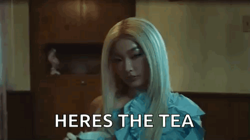 A Close Up Of A Woman 'S Face With The Words Heres The Tea Written Below Her GIF