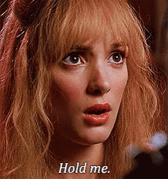 A Close Up Of A Woman 'S Face With The Words `` Hold Me '' Written On Her Face . GIF