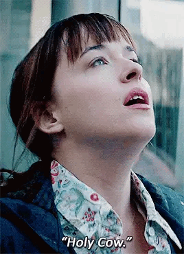 A Close Up Of A Woman 'S Face With The Words `` Holy Cow '' Written On The Bottom . GIF