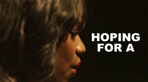 a close up of a woman 's face with the words hoping for a