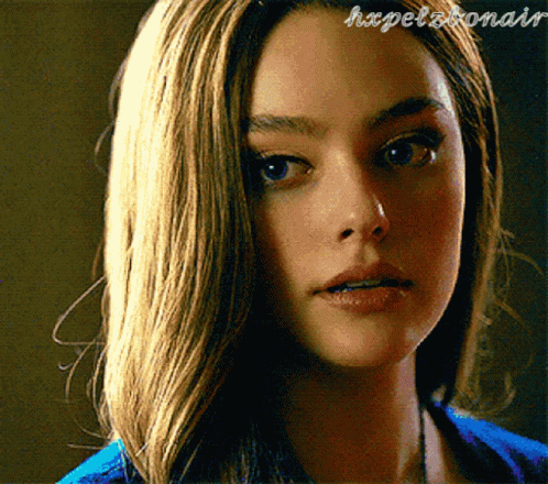 A Close Up Of A Woman 'S Face With The Words Hxpelbonair Written On The Bottom GIF