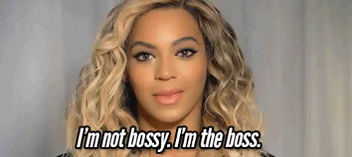 a close up of a woman 's face with the words `` i 'm not bossy , i 'm the boss ''