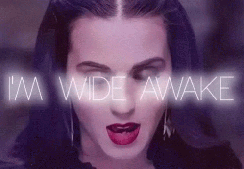 a close up of a woman 's face with the words `` i 'm wide awake '' coming out of her mouth .