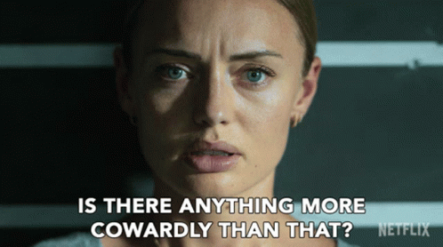 A Close Up Of A Woman 'S Face With The Words " Is There Anything More Cowardly Than That " Below Her GIF
