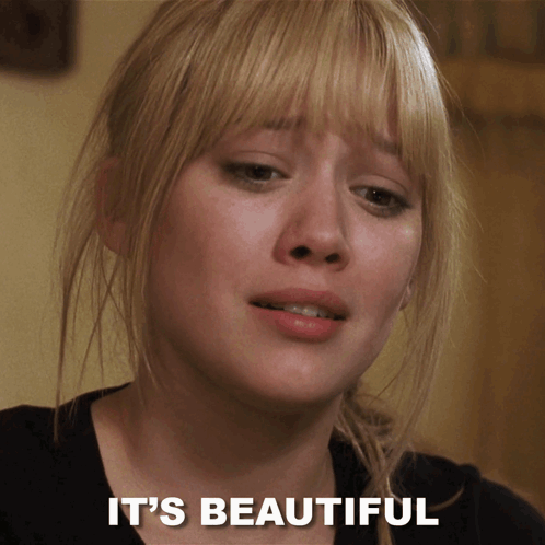 A Close Up Of A Woman 'S Face With The Words " It 'S Beautiful " Below Her GIF