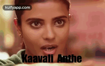 A Close Up Of A Woman 'S Face With The Words Kaavali Anthe Written In Black . GIF