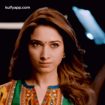 A Close Up Of A Woman 'S Face With The Words Kulfyapp.com At The Top GIF