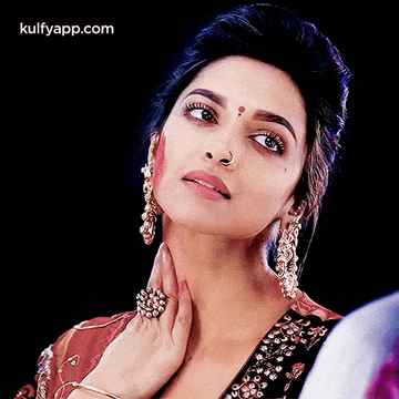A Close Up Of A Woman 'S Face With The Words Kulfyapp.com On The Bottom Right GIF