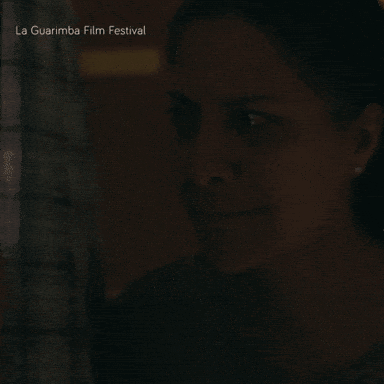 A Close Up Of A Woman 'S Face With The Words La Guarimba Film Festival Below GIF