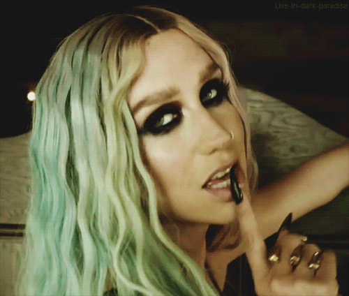 A Close Up Of A Woman 'S Face With The Words Live-In-Dark-Paradise On The Bottom Right GIF