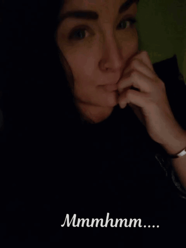 A Close Up Of A Woman 'S Face With The Words Mmmmhmm Written Below It GIF