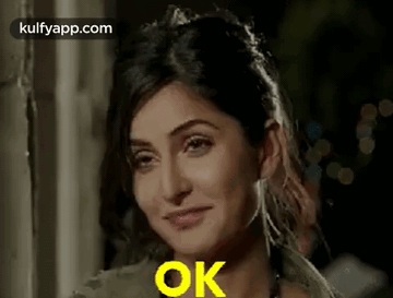 A Close Up Of A Woman 'S Face With The Words `` Ok '' Written On It . GIF
