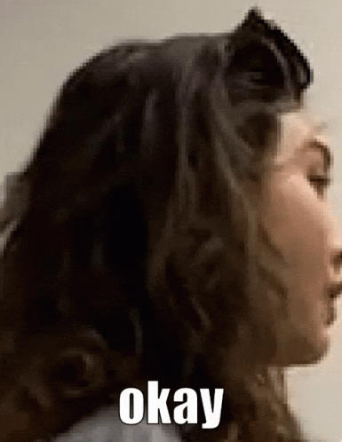 A Close Up Of A Woman 'S Face With The Words Okay Written On The Bottom GIF
