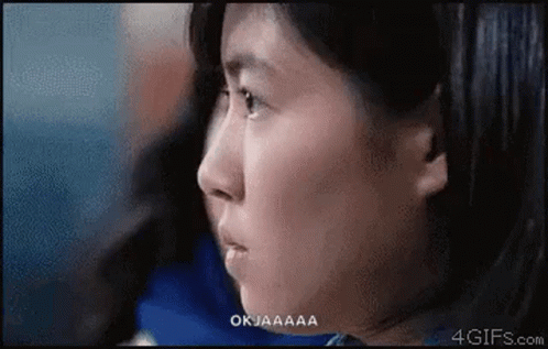 A Close Up Of A Woman 'S Face With The Words Okjaaaa Above Her GIF
