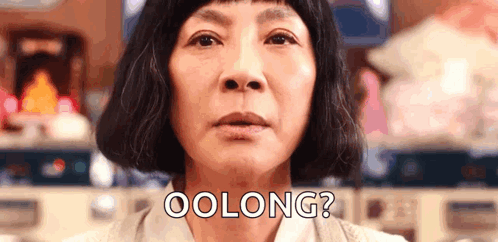 A Close Up Of A Woman 'S Face With The Words `` Oolong '' Written On It . GIF