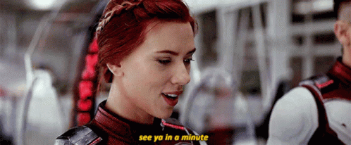 A Close Up Of A Woman 'S Face With The Words `` See Ya In A Minute '' Above Her . GIF