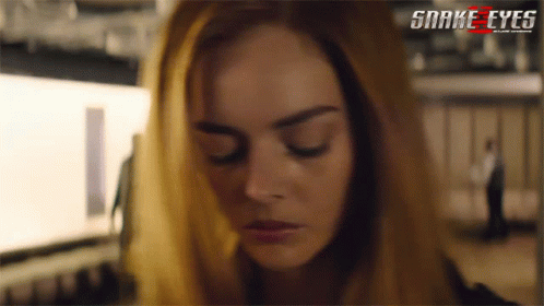 A Close Up Of A Woman 'S Face With The Words Snake Eyes On The Bottom Right GIF