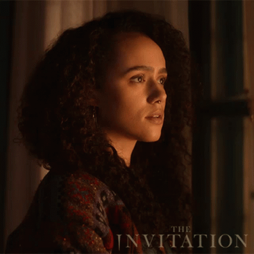 A Close Up Of A Woman 'S Face With The Words " The Invitation " Behind Her GIF