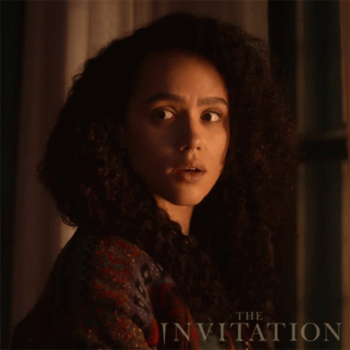 A Close Up Of A Woman 'S Face With The Words " The Invitation " On The Bottom GIF