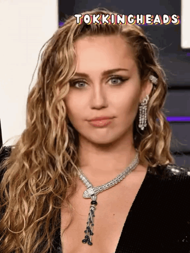 A Close Up Of A Woman 'S Face With The Words Tockingheads Above It GIF