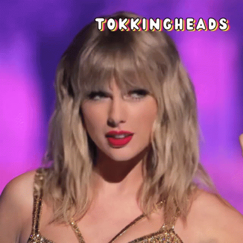 A Close Up Of A Woman 'S Face With The Words Tokingheads Above Her Head GIF