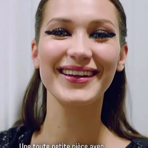 A Close Up Of A Woman 'S Face With The Words " Une Toute Petite Piece Avec " Below Her GIF
