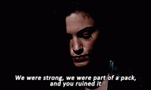 a close up of a woman 's face with the words " we were strong we were part of a pack and you ruined it "