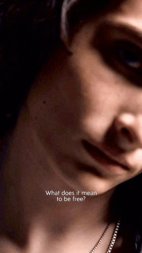 A Close Up Of A Woman 'S Face With The Words " What Does It Mean To Be Free " On The Bottom GIF