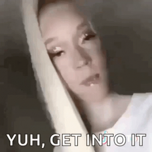 A Close Up Of A Woman 'S Face With The Words `` Yuh , Get Into It '' Written On The Bottom . GIF