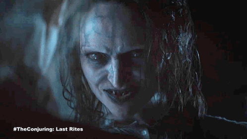 A Close Up Of A Woman 'S Face With #Theconjuring Last Rites Written Below It GIF
