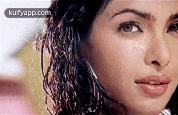 A Close Up Of A Woman 'S Face With Water Drops On Her Face . GIF