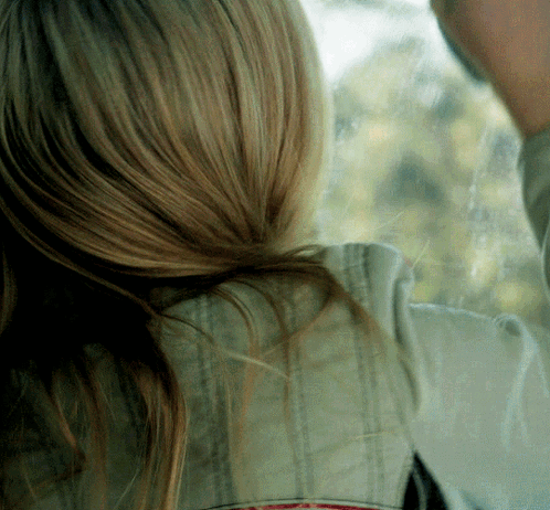 A Close Up Of A Woman 'S Hair And A Man 'S Face GIF
