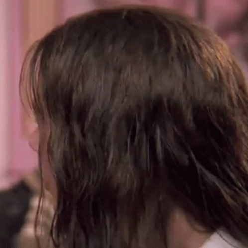 A Close Up Of A Woman 'S Hair In A Room . GIF