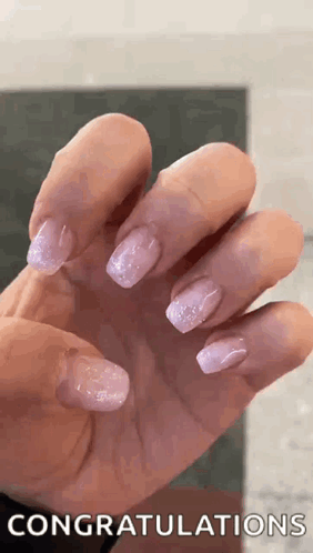 A Close Up Of A Woman 'S Hand With Purple Nails And The Words `` Congratulations '' Written On It . GIF