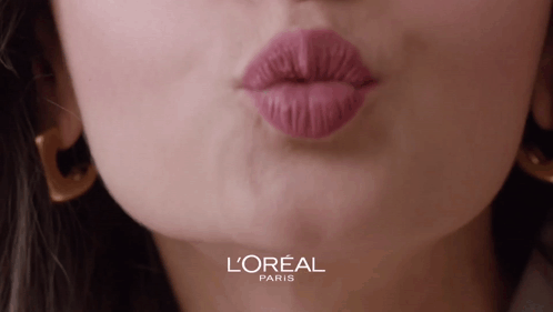 A Close Up Of A Woman 'S Lips With A L' Oreal Paris Logo Behind Her GIF