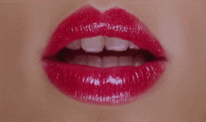 A Close Up Of A Woman 'S Lips With Red Lipstick And White Teeth GIF