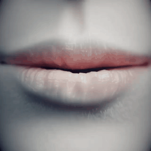 A Close Up Of A Woman 'S Lips With Red Lipstick On Them GIF